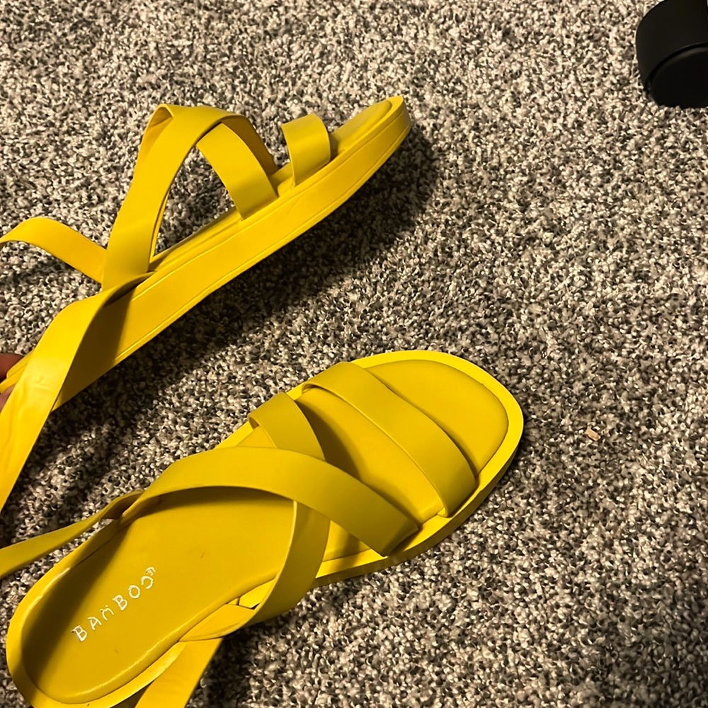 Vibrant yellow summer sandals that wrap around ankle.